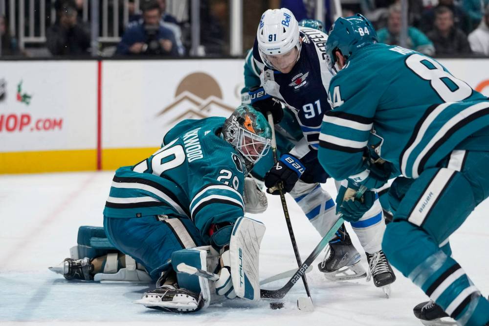 Godofredo A. Vásquez / The Associated Press
San Jose Sharks goaltender Mackenzie Blackwood blocks a shot by Winnipeg Jets centreman Cole Perfetti as Sharks defenceman Jan Rutta defends during the second period.