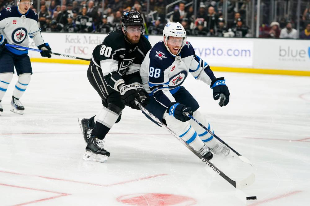 Ryan Sun / The Associated Press
Winnipeg Jets defenceman Nate Schmidt and Los Angeles Kings centre Pierre-Luc Dubois battle for the puck during the second period.