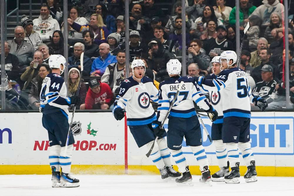 Ryan Sun / The Associated Press
Winnipeg Jets centre Mark Scheifele, right, celebrates with teammates after scoring during the second period against the Los Angeles Kings, Wednesday in Los Angeles.