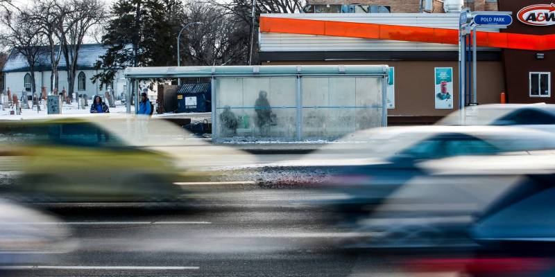 JOHN WOODS / WINNIPEG FREE PRESS
People wait for the bus at the stop on Portage Avenue across from Polo Park.