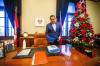 Wab Kinew looks at folders laid out on his desk first thing at his office. (Mikaela MacKenzie / Winnipeg Free Press)