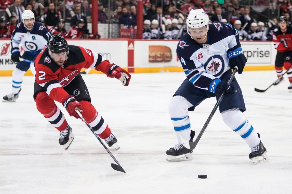 Winnipeg Jets’ defenceman Neal Pionk (right) is at his best when he has an edge to his game. (Frank Franklin II / The Associated Press files)