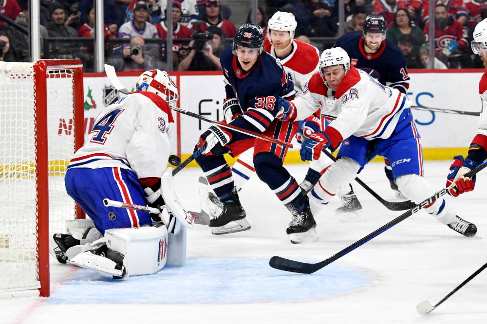 THE CANADIAN PRESS/Fred Greenslade
Montreal Canadiens’ goaltender Jake Allen makes a save on Winnipeg Jets’ Morgan Barron as he is checked by Jesse Ylonen during the second period.