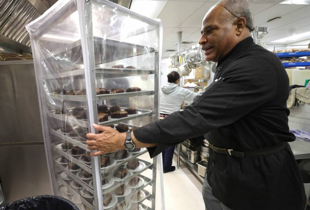 Sous chef Lloyd Reid helps prep hundreds of desserts for a turkey dinner for up to 1,500 guests on Wednesday. (Ruth Bonneville / Winnipeg Free Press)