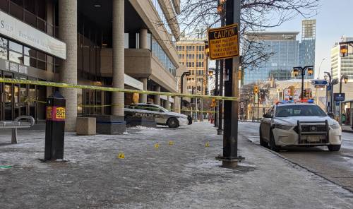 About a dozen yellow evidence markers were placed on the sidewalk in front of the Cargill Building Saturday. (Chris Kitching / Winnipeg Free Press)