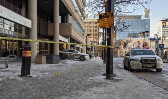 About a dozen yellow evidence markers were placed on the sidewalk in front of the Cargill Building Saturday. (Chris Kitching / Winnipeg Free Press)