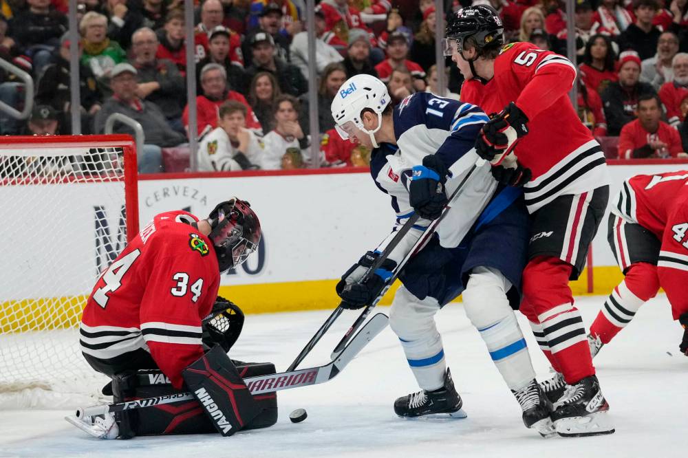 Erin Hooley / The Associated Press
                                Blackhawks goaltender Petr Mrazek thwarts Jets forward Gabriel Vilardi on Wednesday night in Chicago.