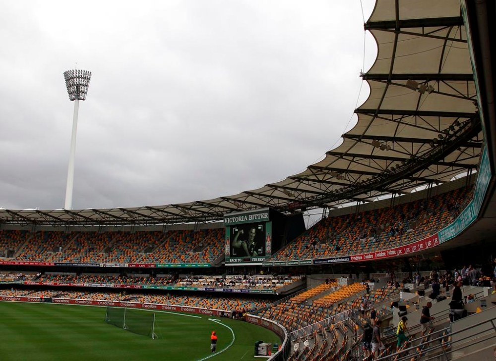 FILE - Spectators make their way home after play had been suspended due to heavy rain during the second day of the first cricket test match between Australia and South Africa at the Gabba stadium in Brisbane, Australia, Saturday, Nov. 10, 2012. The cricket stadium that Brisbane Olympics backers pitched as the centerpiece venue for the 2032 Summer Games is set to be demolished and rebuilt.(AP Photo/Tertius Pickard, File)