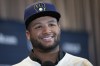 Milwaukee Brewers outfielder Jackson Chourio responds to questions following a news conference at the Major League Baseball winter meetings Monday, Dec. 4, 2023, in Nashville, Tenn. Chourio agreed to the largest contract for a player with no major league experience, an $82 million, eight-year deal with the Brewers. (AP Photo/George Walker IV)
