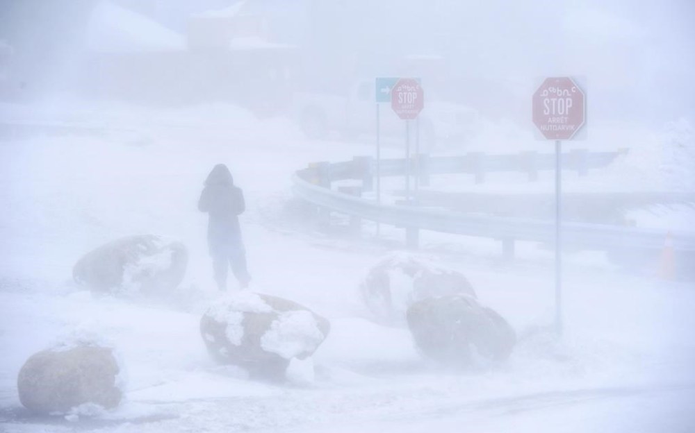 A pedestrian leaves the Iqaluit Airport as a winter storm hits Iqaluit, Nvt., on Thursday, March 7, 2019. THE CANADIAN PRESS/Sean Kilpatrick