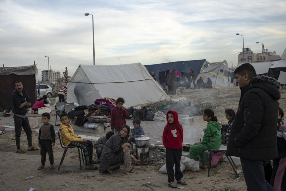 Palestinians displaced by the Israeli ground offensive on the Gaza Strip set up a tent camp in the Muwasi area Thursday, Dec. 7, 2023. AP Photo/Fatima Shbair)