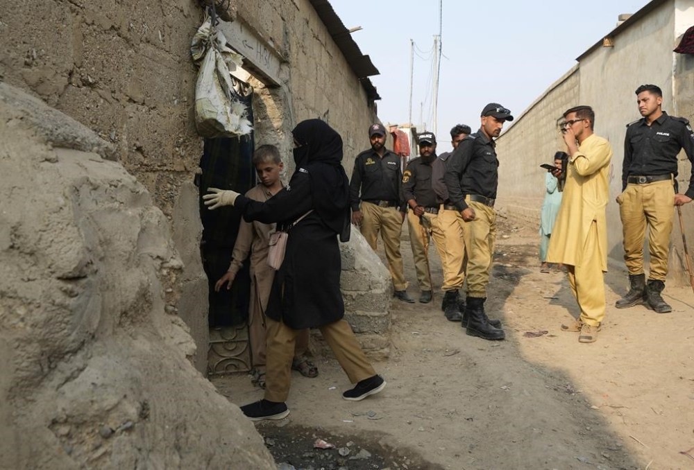 Pakistani police officers conducts biometric identification of a residents during a search operation against illegal immigrants at a neighbourhood of Karachi, Pakistan, Tuesday, Nov. 21, 2023. (AP Photo/Fareed Khan)