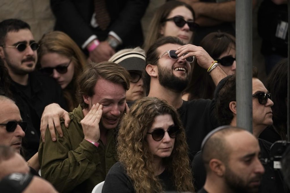 Mourners react during the funeral of Israeli soldier Master Sgt. Gal Meir Eizenkot, 25, who was killed in fighting in Gaza, at the military cemetery in Herzliya, Israel, on Friday, Dec.8, 2023. The death of Eizenkot, the son of Gadi Eizenkot, Israel's former army chief who is also currently a member of Israel's war cabinet, has resonated across the country and drawn condolences from Israel's top leaders (AP Photo/Leo Correa)