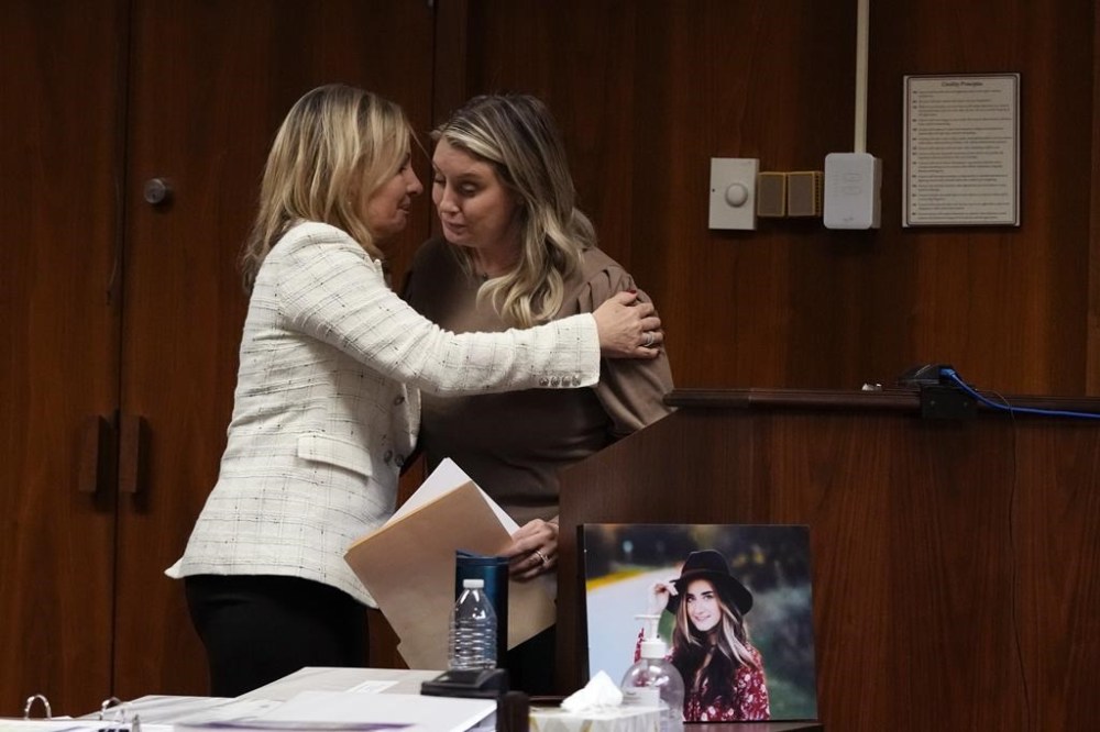 Oakland County prosecutor Karen McDonald hugs Nicole Beausoleil, mother of Madisyn Baldwin, after Nicole's victim impact statement, Friday, Dec. 8, 2023, in Pontiac, Mich. Parents of students killed at Michigan's Oxford High School described the anguish of losing their children Friday as a judge considered whether Ethan Crumbley, a teenager, will serve a life sentence for a mass shooting in 2021. (AP Photo/Carlos Osorio)