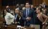 Prime Minister Justin Trudeau rises to vote during an overnight session in the House of Commons, Friday, December 8, 2023 in Ottawa. THE CANADIAN PRESS/Adrian Wyld