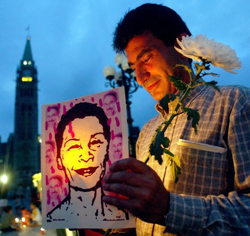 Shahpour Rahanam takes part in a candle-light vigil for Zahra Kazemi held by the Committee for Defence of Human Rights in Iran on Parliament Hill in Ottawa, Tuesday, July 15, 2003. Canada is using a rarely invoked sanctions law that targets corrupt office holders, to join peer countries in taking aim against officials in Russia, Iran and Myanmar. Those listed for sanctions include two senior Iranian officials accused of overseeing the torture of Iranian-Canadian photojournalist Kazemi, who died in custody in 2003. THE CANADIAN PRESS/Chris Wattie