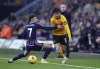 Nottingham Forest's Neco Williams, left, and Wolverhampton Wanderers' Hugo Bueno battle for the ball during the English Premier League soccer match between Nottingham Forest and Wolverhampton Wanderers at the Molineux Stadium in Wolverhampton, England, Saturday Dec. 9, 2023. (Mike Egerton/PA via AP)