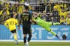 LA Galaxy goaltender Maxime Crepeau (16) blocks a shot in front of Columbus Crew forward Diego Rossi (10) and LA Galaxy's Denis Bouanga, center, in the first half MLS soccer championship match, Saturday, Dec. 9, 2023, in Columbus, Ohio. (AP Photo/Sue Ogrocki)