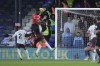 Luton Town's Elijah Adebayo, top, scores his side's opening goal during the English Premier League soccer match between Luton Town and Manchester City at Kenilworth Road stadium in Luton, England, Sunday Dec. 10, 2023. (AP Photo/Kin Cheung)