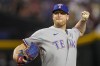 FILE - Texas Rangers relief pitcher Will Smith throws against the Arizona Diamondbacks during the ninth inning in Game 4 of the baseball World Series, Oct. 31, 2023, in Phoenix. Left-handed reliever Smith, who has won World Series rings the past three seasons with three different organizations, has agreed to a $5 million contract with the Royals, a person with knowledge of the deal told The Associated Press on Sunday, Dec. 10. (AP Photo/Brynn Anderson, File)
