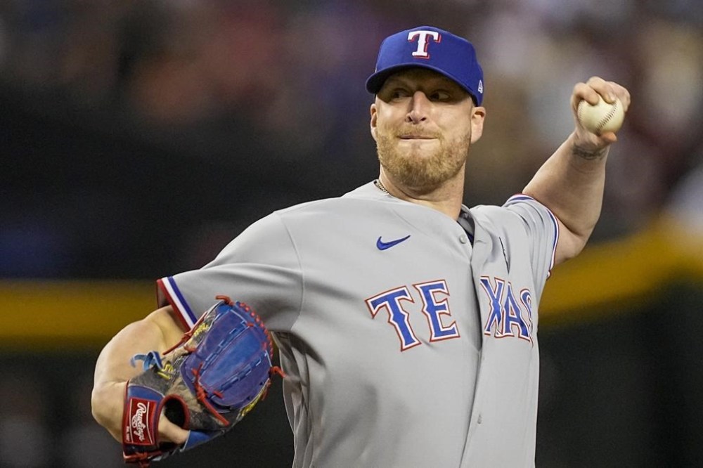 FILE - Texas Rangers relief pitcher Will Smith throws against the Arizona Diamondbacks during the ninth inning in Game 4 of the baseball World Series, Oct. 31, 2023, in Phoenix. Left-handed reliever Smith, who has won World Series rings the past three seasons with three different organizations, has agreed to a $5 million contract with the Royals, a person with knowledge of the deal told The Associated Press on Sunday, Dec. 10. (AP Photo/Brynn Anderson, File)