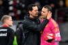 Frankfurt coach Dino Toppmoeller hugs Munich goalkeeper Manuel Neuer, right, after the German Bundesliga soccer match between Eintracht Frankfurt and Bayern Munich at Deutsche Bank Park in Frankfurt, Germany, Saturday, Dec. 9, 2023. (Arne Dedert/dpa via AP)