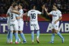 Girona's Artem Dovbyk, left, celebrates with teammates after scoring the opening goal during the Spanish La Liga soccer match between Barcelona and Girona at the Olimpic Lluis Companys stadium in Barcelona, Spain, Sunday, Dec. 10, 2023. (AP Photo/Joan Monfort)