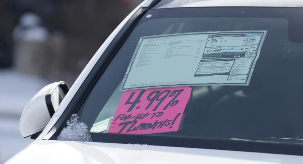 A sign highlighting the financing interest rate is displayed near the price sticker on an unsold 2023 vehicle at a Mercedes-Benz dealer on Thursday, Nov. 30, 2023, in Loveland, Colo. On Tuesday, the Labor Department issues its report on inflation at the consumer level in November. (AP Photo/David Zalubowski)
