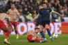 Lens' Neil El Aynaoui, centre bottom, kicks the ball ahead of Sevilla's Ivan Rakitic, right, during the Champions League Group B soccer match between Lens and Sevilla at the Bollaert stadium in Lens, France, Tuesday, Dec. 12, 2023. (AP Photo/Thibault Camus)