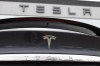FILE - The Tesla company logo shines off the rear deck of an unsold 2020 Model X at a Tesla dealership, April 26, 2020, in Littleton, Colo. On Tuesday, Dec. 12, 2023, Virginia authorities determined that a Tesla was operating on its Autopilot system and was speeding in the moments leading to a crash with a crossing tractor-trailer last July that killed the Tesla driver. (AP Photo/David Zalubowski, File)