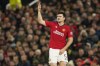 Injured Manchester United's Harry Maguire gestures as he walks off to be substituted during the group A Champions League soccer match between Manchester United and Bayern Munich at the Old Trafford stadium in Manchester, England, Tuesday, Dec. 12, 2023. (AP Photo/Dave Thompson)
