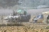 Israeli forces evacuate a wounded soldier from Gaza, near the border between Gaza and southern Israel on Tuesday, Dec. 12, 2023. (AP Photo/Tsafrir Abayov)