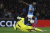 Napoli's Victor Osimhen, right, scores his side's second goal of the game during the Champions League group C soccer match between Napoli and Braga at the Diego Armando Maradona stadium in Naples, Italy, Tuesday, Dec. 12, 2023. (Alessandro Garofalo/LaPresse via AP)