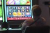 A gambler plays a slot machine at Harrah's casino in Atlantic City, N.J., on Sept. 29, 2023. THE CANADIAN PRERSS/AP-Wayne Parry
