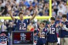 Former New England Patriots quarterback Tom Brady raises his arms after speaking while standing next to his daughter Vivian and sons Benjamin and Jack during the halftime ceremony of an NFL football game against the Philadelphia Eagles, Sunday, Sept. 10, 2023, in Foxborough, Mass. THE CANADIAN PRESS/AP-Greg M. Cooper