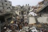 Palestinians salvage their belongings after an Israeli strike in Rafah, Gaza Strip, on Wednesday, Dec. 13, 2023. (AP Photo/Hatem Ali)