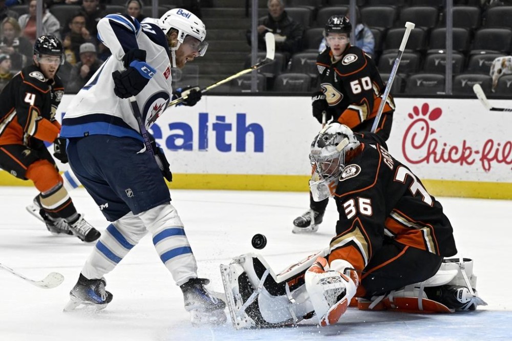 Anaheim Ducks goaltender John Gibson, right, stops a shot by Winnipeg Jets left wing Kyle Connor during the first period of an NHL hockey game in Anaheim, Calif., Sunday, Dec. 10, 2023. The Jets have placed leading scorer Connor on injured reserve with a knee injury. THE CANADIAN PRESS/AP/Alex Gallardo
