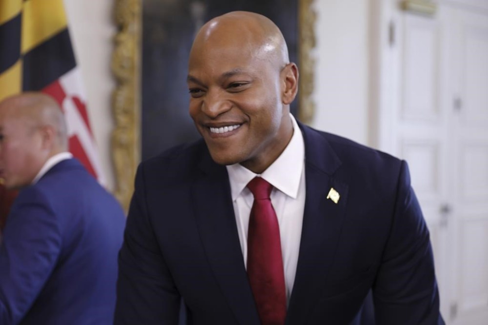 Maryland Gov. Wes Moore smiles as he gives reporters an update on negotiations with the Baltimore Orioles about a new lease during a news conference on Wednesday, Dec. 13, 2023 in Annapolis, Md. Moore said he believes a new lease agreement is