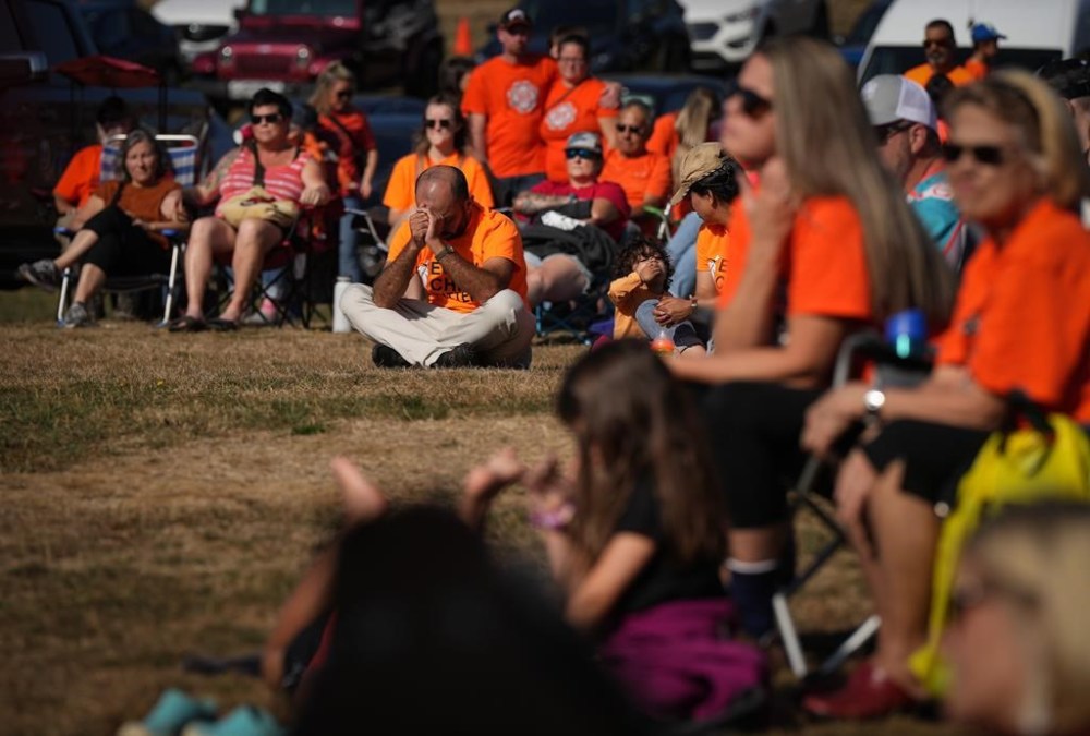 A report from a group of researchers at three Canadian universities suggests the public's awareness of the past harms of residential schools has increased, but that more work needs to be done around educating Canadians on the last impacts. People listen during a ceremony to mark the National Day for Truth and Reconciliation at the site of the former St. Mary's Indian Residential School, in Mission, B.C., on Friday, Sept. 30, 2022. THE CANADIAN PRESS/Darryl Dyck