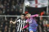 Newcastle's Tino Livramento, left, and AC Milan's Christian Pulisic go for a header during the Champions League group F soccer match between Newcastle United and AC Milan at St. James' Park, in Newcastle, England, Wednesday, Dec. 13, 2023. (AP Photo/Scott Heppell)