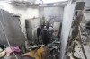 Palestinians salvage belongings after an Israeli strike on residential buildings in Rafah, Gaza Strip, on Thursday, Dec. 14, 2023. (AP Photo/Hatem Ali)