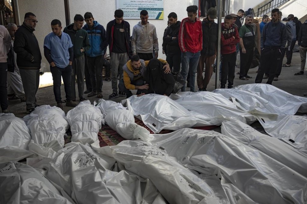 Palestinians mourn their relatives killed in the Israeli bombardment of the Gaza Strip, at the hospital Rafah, Gaza, Tuesday, Dec. 12, 2023. (AP Photo/Fatima Shbair)