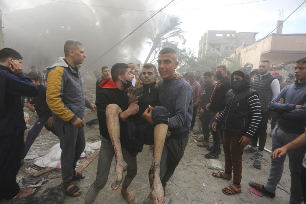 Palestinians evacuate survivors of an Israeli strike in Rafah, Gaza Strip, Thursday, Nov. 14, 2023. (AP Photo/Hatem Ali)