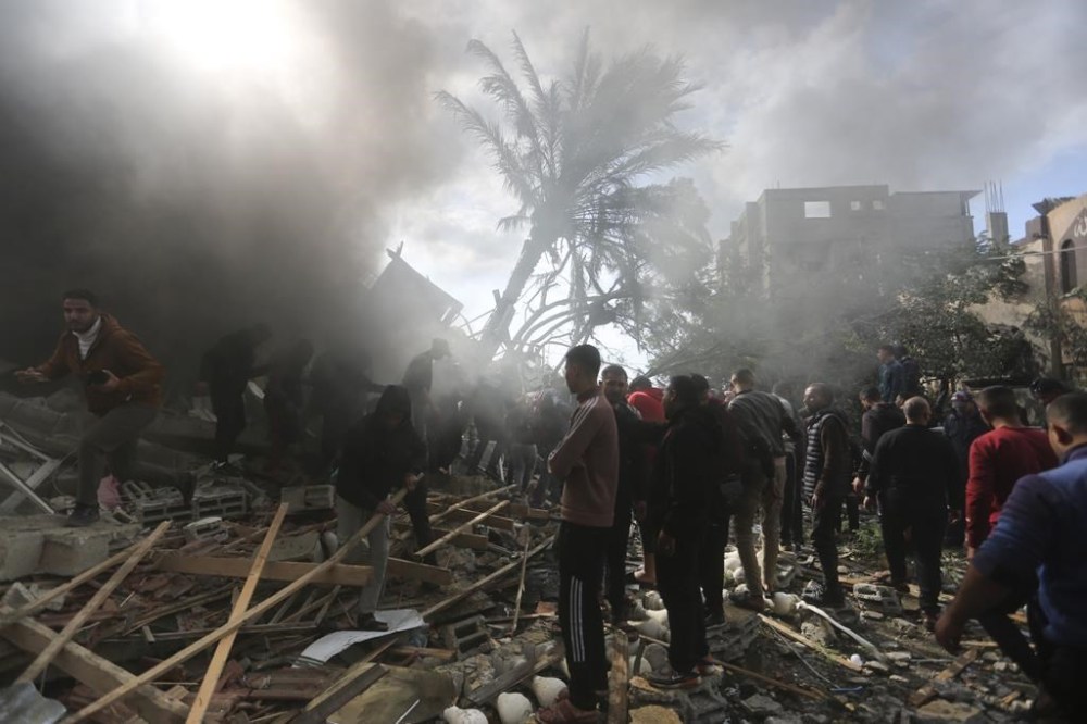 Palestinians look for the survivors of an Israeli strike in Rafah, Gaza Strip, Thursday, Nov. 14, 2023. (AP Photo/Hatem Ali)