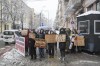 Activists hold signs reading 