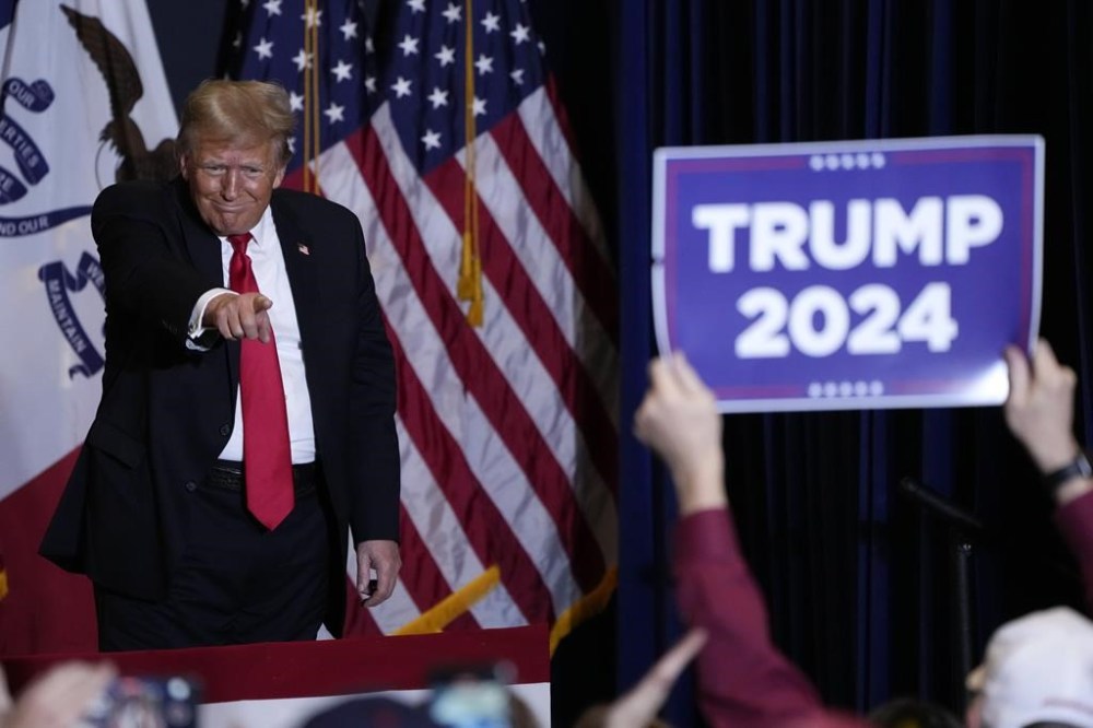 Former President Donald Trump walks off stage during a commit to caucus rally, Wednesday, Dec. 13, 2023, in Coralville, Iowa. (AP Photo/Charlie Neibergall)