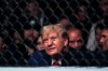FILE - Former President Donald Trump waits for the start of the lightweight bout between Matt Frevola and Benoit Saint Denis, of France, at the UFC 295 mixed martial arts event Saturday, Nov. 11, 2023, in New York. Trump has spent less time campaigning in early-voting states than many of his Republican primary rivals. But his campaign has been bolstering his schedule with appearances at major sporting events, including this weekend’s Edwards vs. Covington UFC fight in Las Vegas. (AP Photo/Frank Franklin II, File)