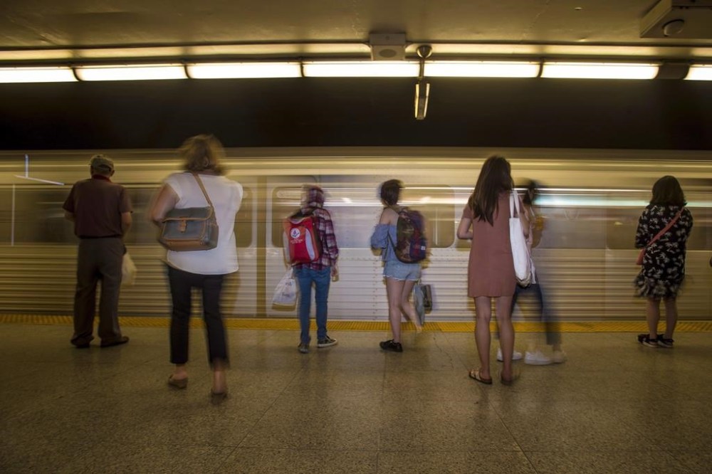 Telus Corp. and Bell Canada customers now have wireless service in all TTC subway stations and additional tunnel areas after Rogers Communications Inc. expanded access for its own customers nearly a month ago. Commuters wait to take the subway at Christie Station in Toronto on Friday, June 22, 2018. THE CANADIAN PRESS/Tijana Martin