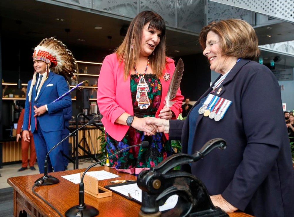 Manitoba Premier Wab Kinew looks on as Bernadette Smith, Minister of Housing, Addictions and Homelessness and Minister responsible for Mental Health is sworn in by Lt. Gov. Anita Neville at a swearing-in ceremony in Winnipeg, Wednesday, Oct. 18, 2023. The Manitoba government is spending $2.8 million on supportive housing units to address homelessness. THE CANADIAN PRESS/John Woods