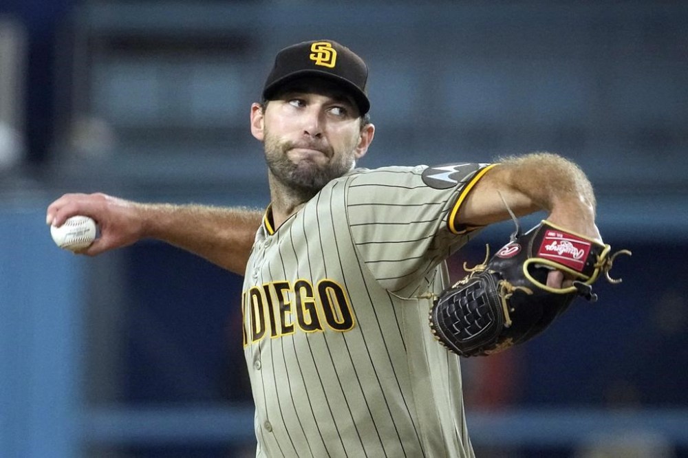 FILE - San Diego Padres starting pitcher Michael Wacha throws to the plate during the first inning of a baseball game against the Los Angeles Dodgers, Sept. 12, 2023, in Los Angeles. The Kansas City Royals made a pair of free-agent moves Friday, agreeing to a $32 million, two-year contract with pitcher Michael Wacha and a a $13 million, two-year deal with outfielder Hunter Renfroe. people familiar with the negotiations told The Associated Press. The people spoke on condition of anonymity Friday, Dec. 15, 2023, because the agreements had not been announced. (AP Photo/Mark J. Terrill, File)